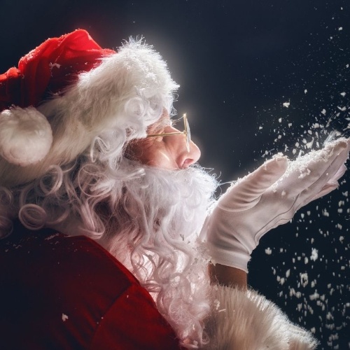 A picture of Santa blowing a handful of snow